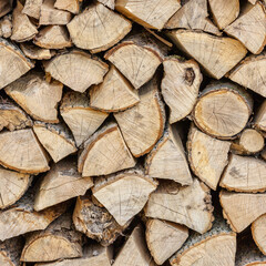 Background of hewed smooth wooden logs. Cut wood texture. Pile of chopped fire wood prepared for winter