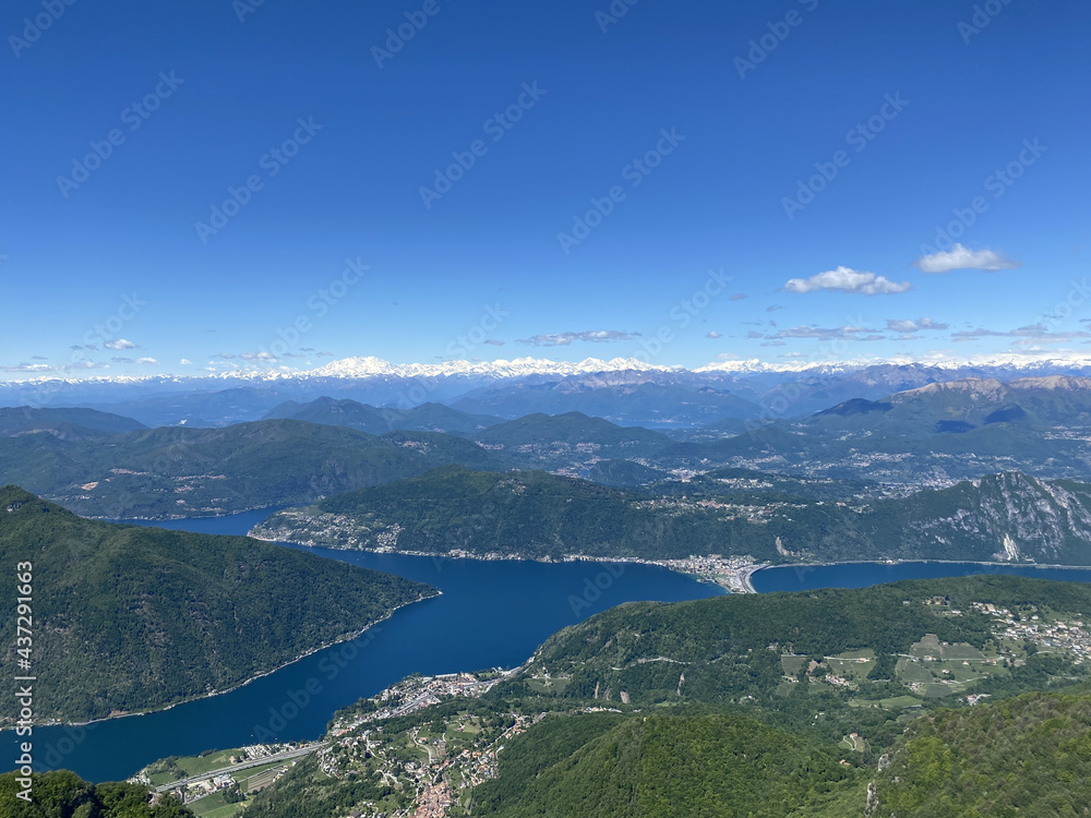 Poster aerial shot of the lake lugano castel and its surroundings in switzerland