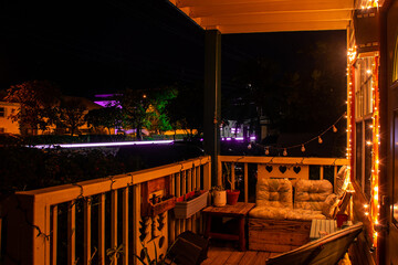 A shot of a cosy looking balcony at night with street lights in the background