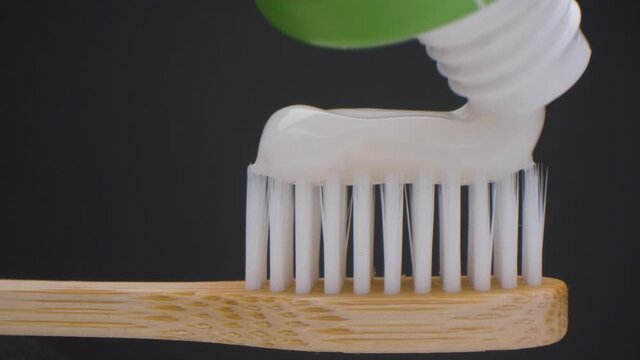 Super close up view of toothpaste with toothbrush. Beautiful slider shot of toothpaste. White teeth.