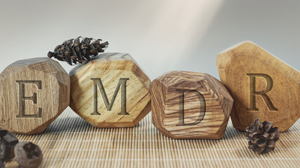 Letters EMDR written on wooden irregular blocks. Eye Movement Desensitization and Reprocessing...