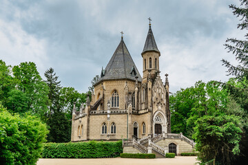 Fototapeta na wymiar Spring view of Schwarzenberg Tomb near Trebon, Czech Republic.Neo-gothic building with tower and majestic double staircase is surrounded by English park.Architectural popular tourist monument