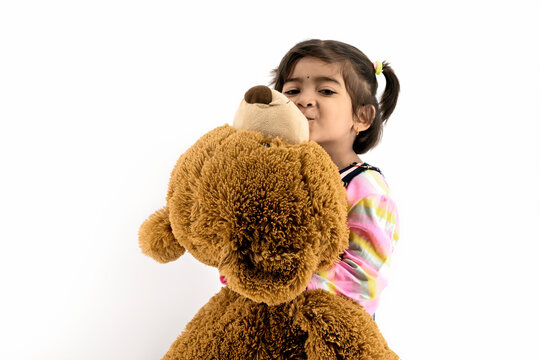 Girl kid Cheerful Studio Portrait Concept with happy smiling with hugging /Kissing teddy bear, best friend concept with white background