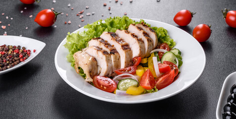 Fresh delicious salad with chicken, tomato, cucumber, onions and greens with olive oil