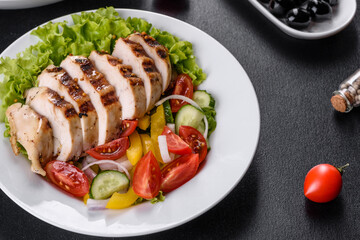 Fresh delicious salad with chicken, tomato, cucumber, onions and greens with olive oil
