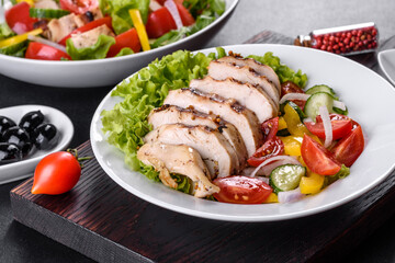 Fresh delicious salad with chicken, tomato, cucumber, onions and greens with olive oil