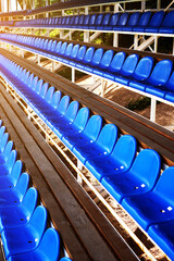 Fototapeta premium blue plastic seats in the sports arena. chairs on the football field. arena