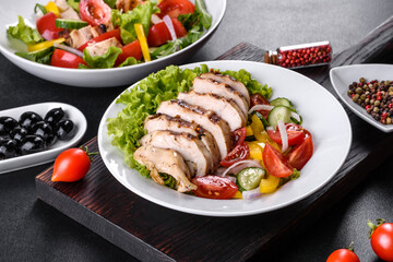 Fresh delicious salad with chicken, tomato, cucumber, onions and greens with olive oil