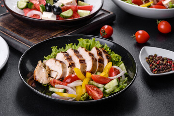 Fresh delicious salad with chicken, tomato, cucumber, onions and greens with olive oil