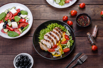 Fresh delicious salad with chicken, tomato, cucumber, onions and greens with olive oil