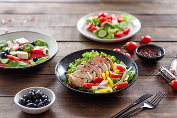 Fresh delicious salad with chicken, tomato, cucumber, onions and greens with olive oil