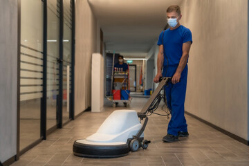 Cleaner maintains hard floor with polishing machine - obrazy, fototapety, plakaty