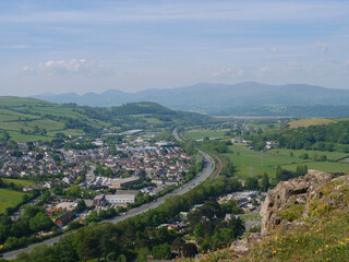 Fototapeta na wymiar Cars driving on Welsh A55 motorway by Mochdre village and Snowdonia mountains view from cliff