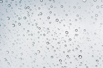 Raindrops on a transparent surface. Transparent drops of water on glass.