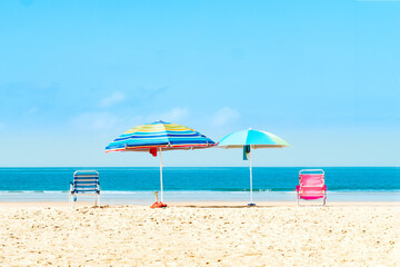 Quiet beach with umbrellas and chairs. Selective focus
