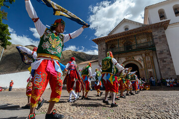 Peruvian folkloric dance, with colorful costumes in front of The Church of San Pedro Apostle of Andahuaylillas, Quispicanchi, near Cusco, Peru on October 7, 2014. - obrazy, fototapety, plakaty