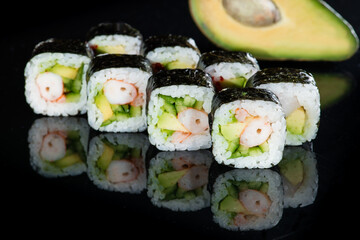 Japanese cuisine. Appetizing maki sushi rolls with rice, avocado
