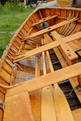 Fototapeta na wymiar Beautiful handcrafted rowboat sitting in the rain