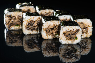 Japanese cuisine. Appetizing maki sushi rolls with rice, mushroo