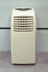 Mobile floor-standing air conditioner in an office or shop