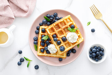 Fototapeta na wymiar Waffles with cream cheese and fresh blueberries, healthy food, breakfast. Waffles with berries.
