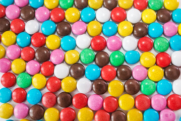  colorful chocolate candies as background.