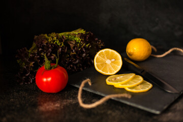 Lemon and tomato on a dark background