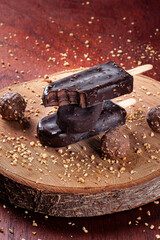 Ice cream covered with chocolate and chestnuts. Chocolate and stuffed popsicles. Copy space