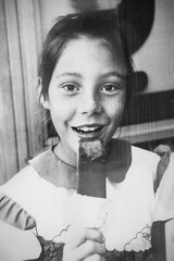 Retro portrait of a Soviet girl with ice cream popsicle. Vintage black and white paper photo. Early...