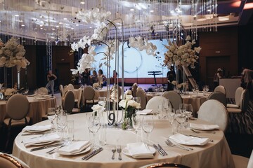 tableware Glasses, flower fork, knife served for dinner in restaurant with cozy interior