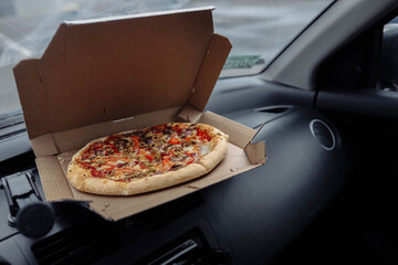 vegetarian pizza in the interior of the car