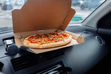 vegetarian pizza in the interior of the car