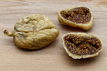 Tasty dried figs fruit on wooden table. Sweet natural dessert. Healthy eating and proper lifestyle.