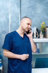 Handsome male doctor in his office. Medical and health care concept.