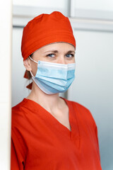 Fototapeta na wymiar Portrait of attractive female doctor on hospital corridor. Medical and health care concept.