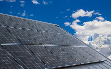 Photovoltaic panels, renewable and eco-sustainable solar energy. Solar panels and blue sky with clouds.