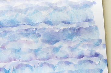 random, abstract watercolor background in layered purple and blue pigments