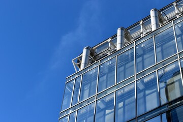 roof top of a building with pipes and glass windows