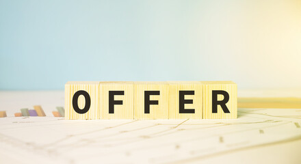 Concept of making an offer on something. Cubes on financial reports.