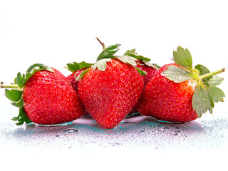 Red juicy strawberry with water droplets on a white background. Produce product