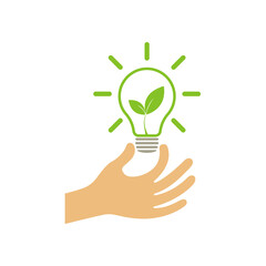 A hand holds a light bulb with a green leaf. Business idea concept