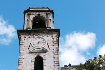 Fototapeta na wymiar Clock Tower of the Cathedral of St. Tryphon against the blue sky. Kotor Montenegro