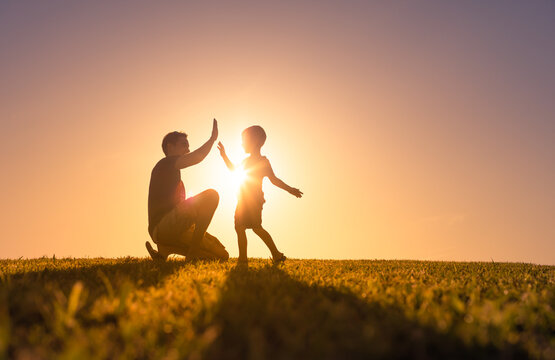 Happy father playing with his son giving him a high five. Father son relationship concept Stock Photo | Adobe Stock Happy father playing with his son giving him a high five. Father son relationship concept Stock Photo | Adobe Stock