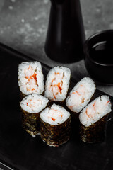 Simple maki with shrimp. Sushi on a gray background