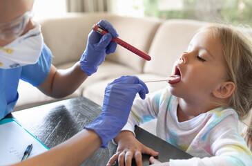 doctor examining child mouth