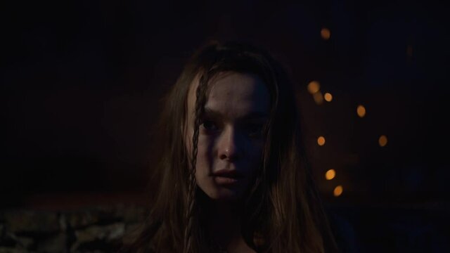 portrait of a girl at night on the background of the fire