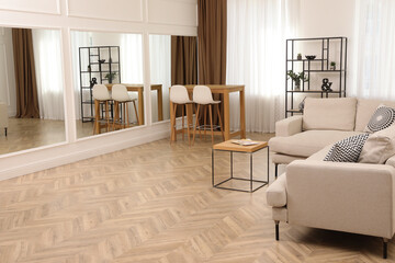 Modern living room with parquet flooring and stylish furniture