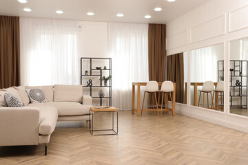 Naklejka na ściany i meble Modern living room with parquet flooring and stylish furniture