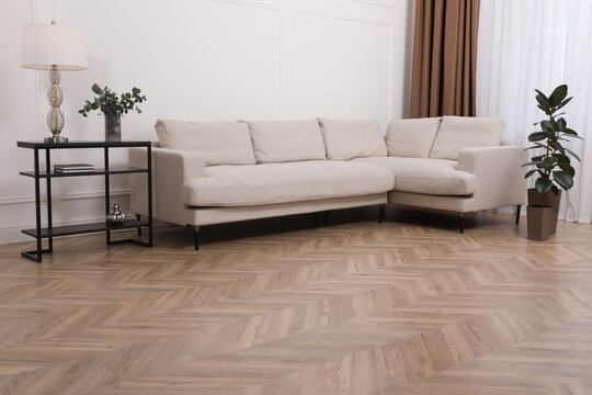 Modern living room with parquet flooring and stylish furniture