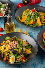 Four different types of salads served freshly on blue stone table